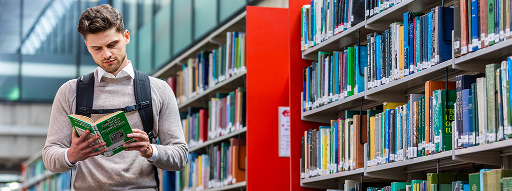 UCD student reading in the library.